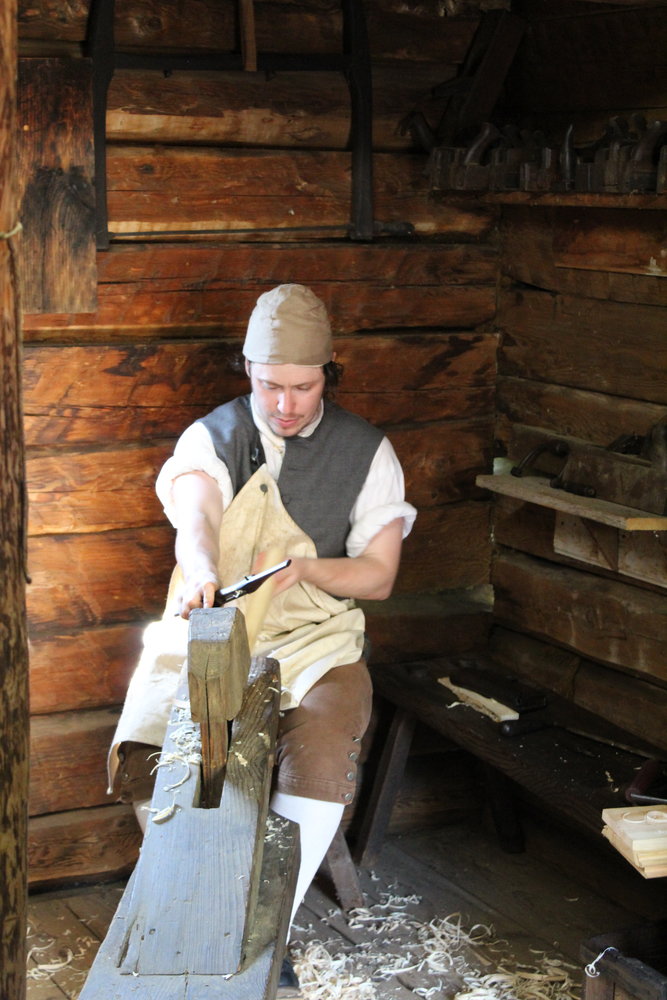 Arden Showers uses a draw shave to make a tool handle at Fort Delaware recently.